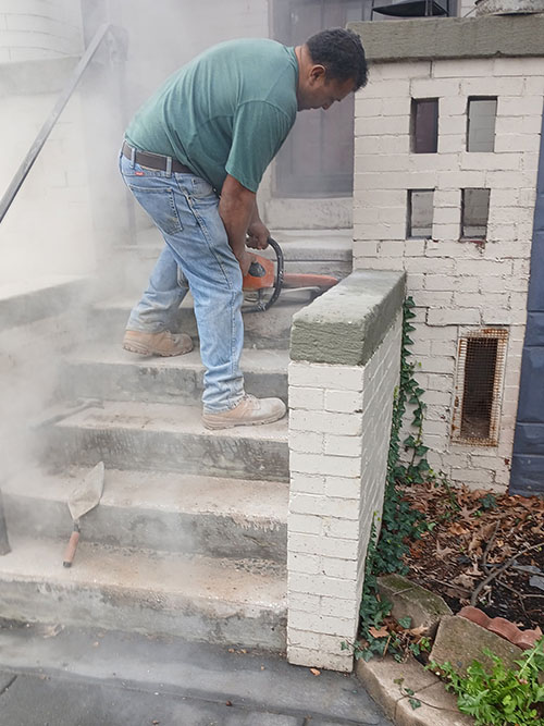 Grinding down old concrete layer